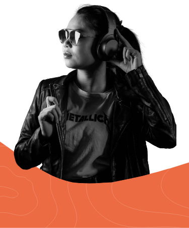 In black and white, a black haired woman in a leather jacket, sunglasses and wearing large headphones, facing her left. She's holding one of the ears of her headphones with one hand and the lapel of her jacket with the other. Her shirt has the logo of metal band "Metallica". Her lower body is partially obstructed by a curved shape in Magroove's orange color.